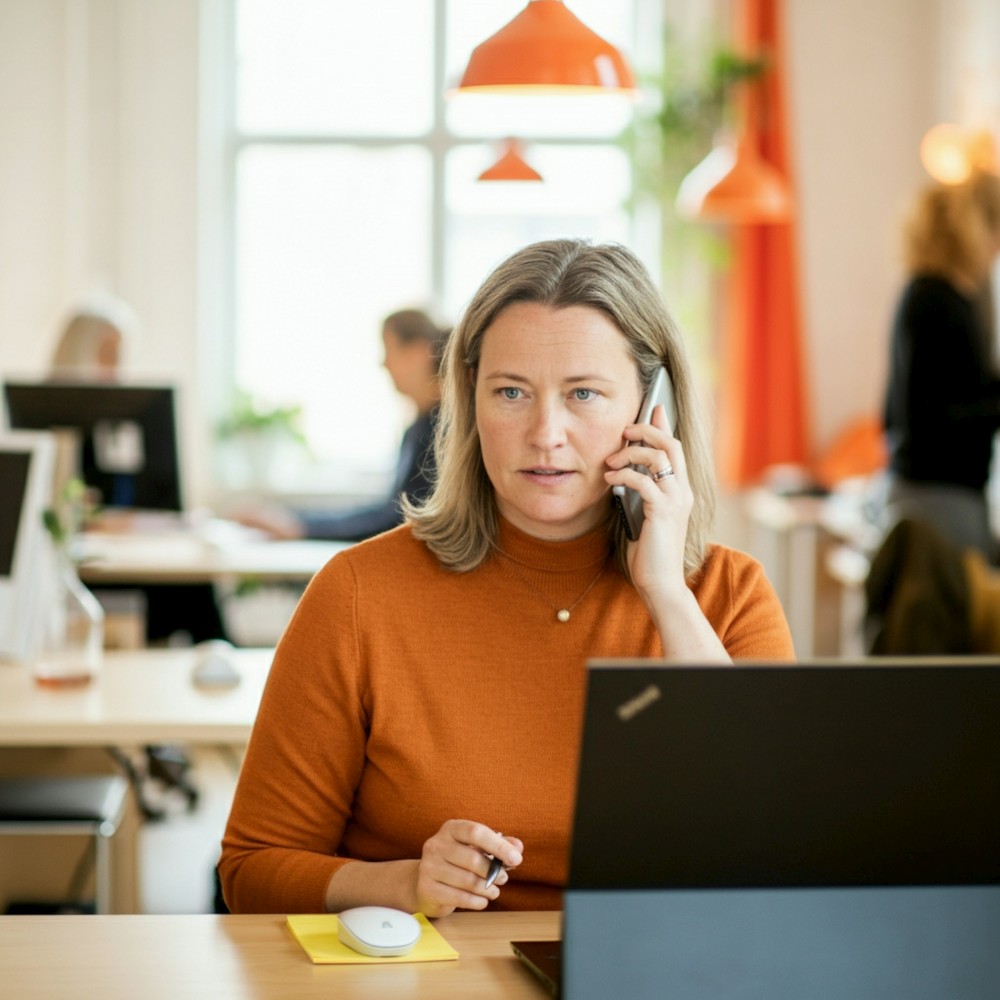 Woman in office on phone 1000
